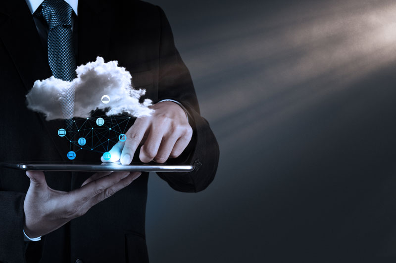 Buying Into the Cloud man holding computer and phone connected with cloud